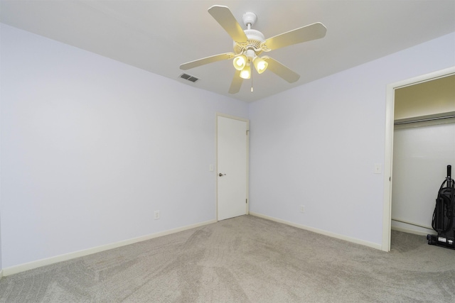 unfurnished bedroom with ceiling fan, a closet, and light carpet