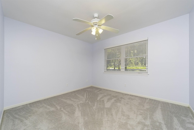 empty room with ceiling fan and light colored carpet