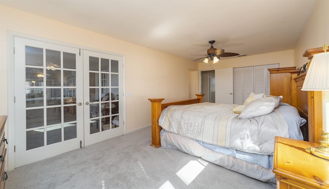 carpeted bedroom with french doors, a closet, and ceiling fan