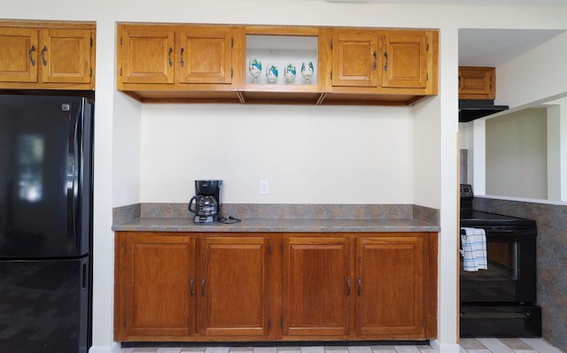 kitchen featuring black appliances and range hood