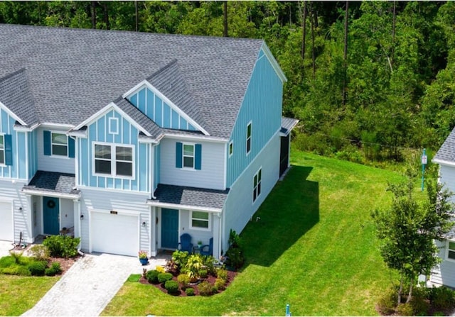 view of front of property with a garage and a front lawn