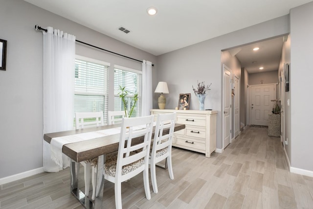 dining space with light hardwood / wood-style flooring