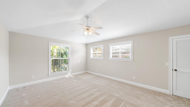 unfurnished room with lofted ceiling, light colored carpet, and ceiling fan