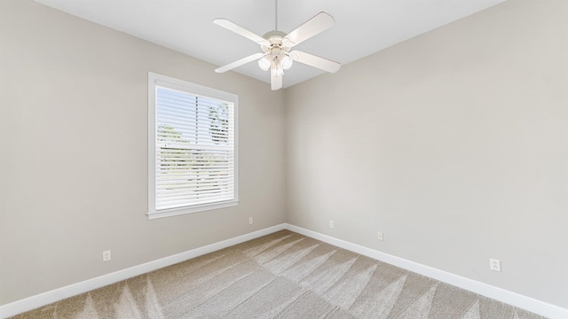 carpeted spare room featuring ceiling fan