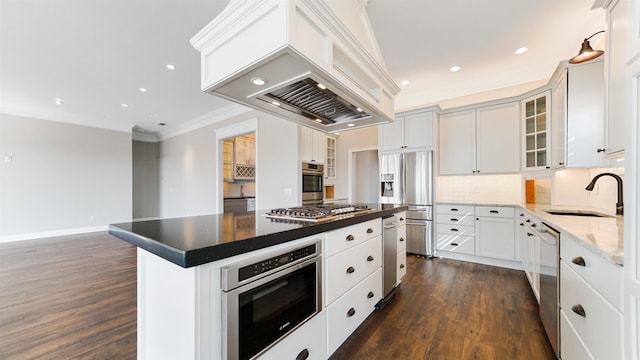 kitchen with premium range hood, a kitchen island, appliances with stainless steel finishes, sink, and white cabinets