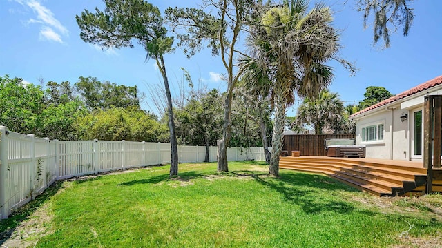 view of yard featuring a hot tub and a deck