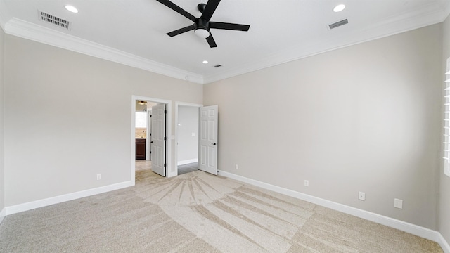 unfurnished bedroom featuring connected bathroom, crown molding, light colored carpet, and ceiling fan