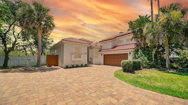 mediterranean / spanish house with a garage