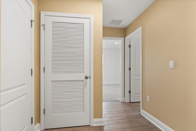 hallway with light hardwood / wood-style flooring