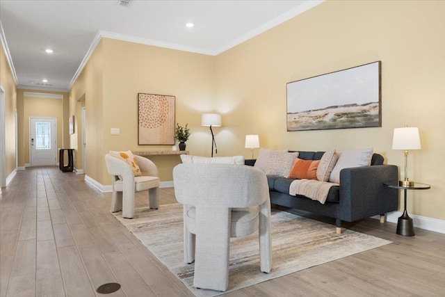 living room with crown molding and light hardwood / wood-style flooring