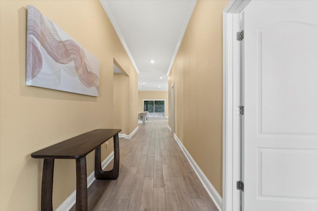 hall featuring ornamental molding and hardwood / wood-style floors