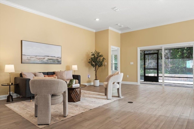 living room with ornamental molding, plenty of natural light, and light wood-type flooring