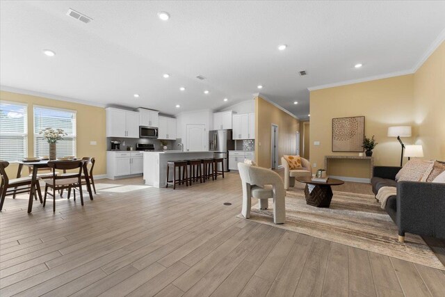 living room featuring crown molding and light wood-type flooring