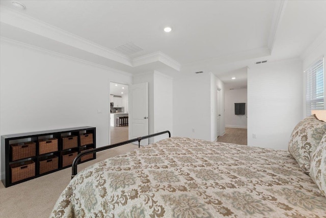 carpeted bedroom featuring a raised ceiling and crown molding