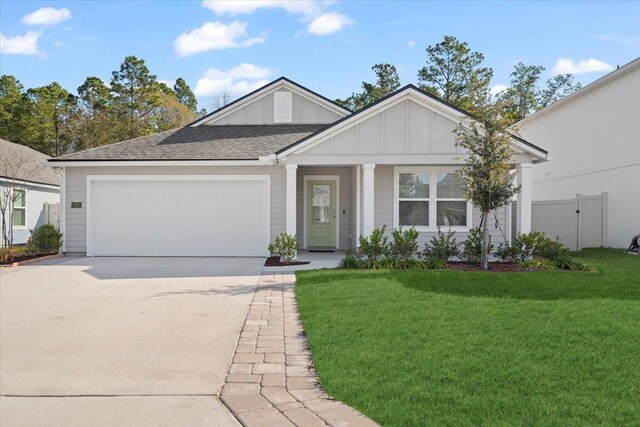 view of front of house featuring a garage and a front lawn