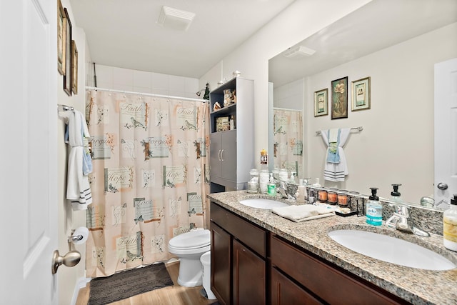 bathroom featuring hardwood / wood-style flooring, vanity, curtained shower, and toilet