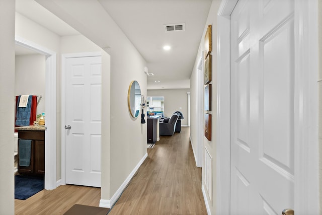 hall with light hardwood / wood-style floors