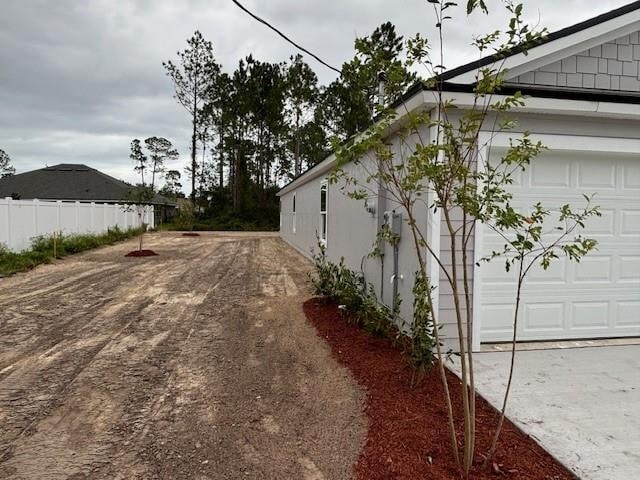 view of side of property featuring a garage