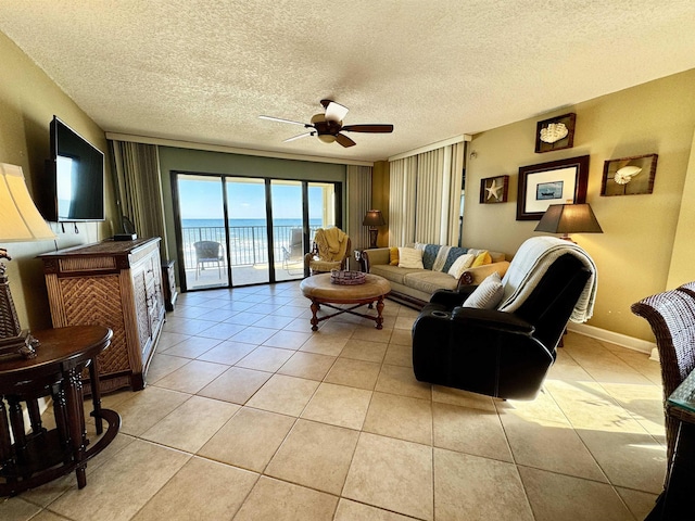 tiled living room with ceiling fan and a textured ceiling