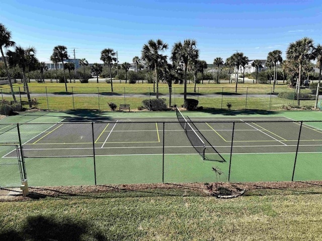 view of sport court with a yard