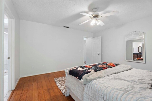 4053 Red Pine Ln, Saint Augustine, FL 32086 - bedroom with wood finished floors, a textured ceiling, and a ceiling fan
