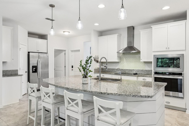 295 Deerfield Meadows Cir, Saint Augustine, FL 32086 - kitchen with appliances with stainless steel finishes, wall chimney range hood, white cabinets, decorative backsplash, and recessed lighting