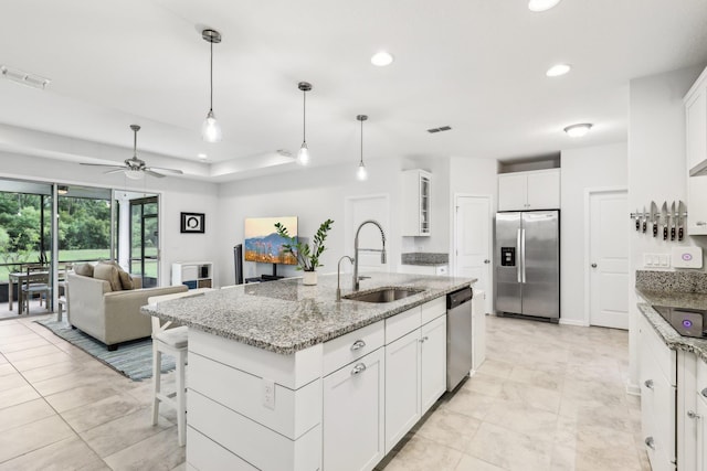 295 Deerfield Meadows Cir, Saint Augustine, FL 32086 - kitchen with appliances with stainless steel finishes, recessed lighting, a kitchen island with sink, a ceiling fan, and white cabinetry