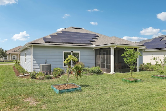 295 Deerfield Meadows Cir, Saint Augustine, FL 32086 - rear view of house featuring solar panels, roof with shingles, and a lawn