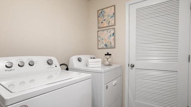 clothes washing area featuring washer and clothes dryer