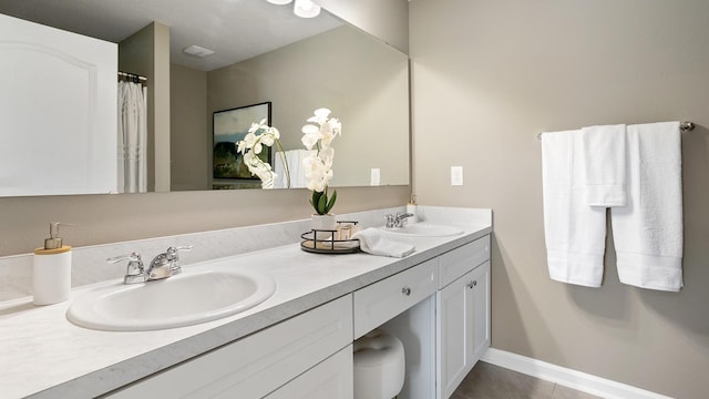 bathroom featuring tile patterned flooring and vanity