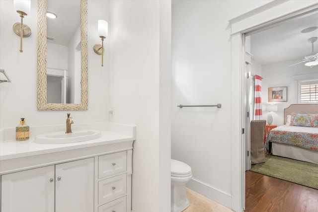 48 Osceola St, Saint Augustine, FL 32084 - bathroom with toilet, wood finished floors, baseboards, ceiling fan, and vanity