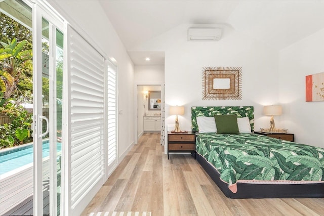 48 Osceola St, Saint Augustine, FL 32084 - bedroom featuring an AC wall unit, light wood-style flooring, and vaulted ceiling