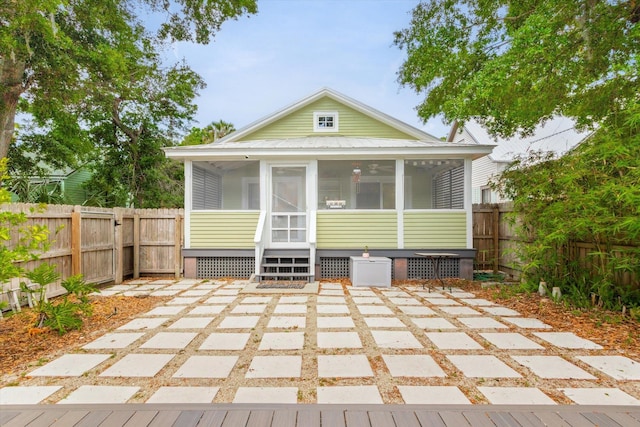 48 Osceola St, Saint Augustine, FL 32084 - back of property with a fenced backyard, a sunroom, and a patio