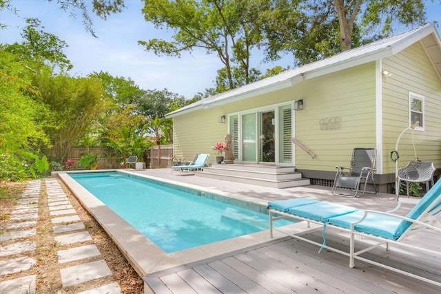 48 Osceola St, Saint Augustine, FL 32084 - view of swimming pool with entry steps, a fenced backyard, a wooden deck, and a fenced in pool