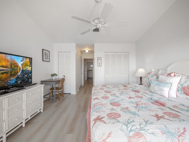 bedroom featuring light hardwood / wood-style floors, ceiling fan, and multiple closets