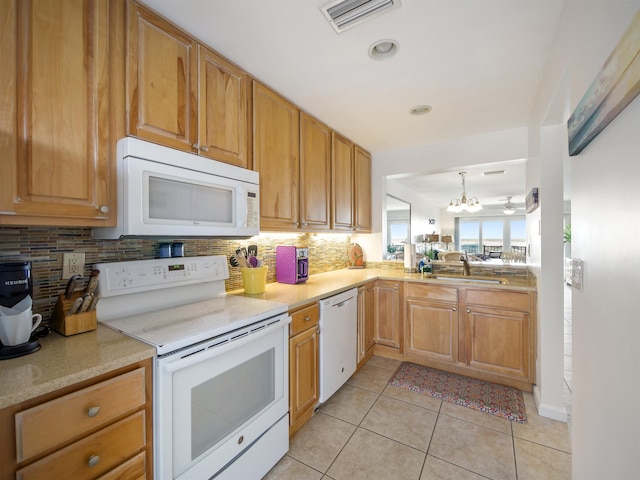 kitchen with sink, a chandelier, white appliances, decorative backsplash, and light tile patterned floors