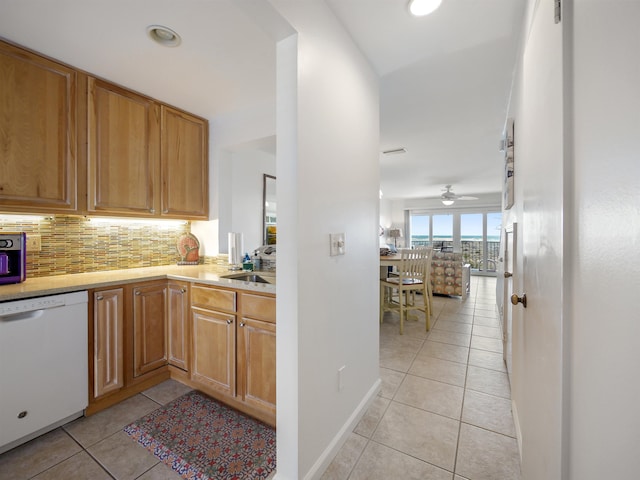 kitchen with ceiling fan, sink, tasteful backsplash, white dishwasher, and light tile patterned floors