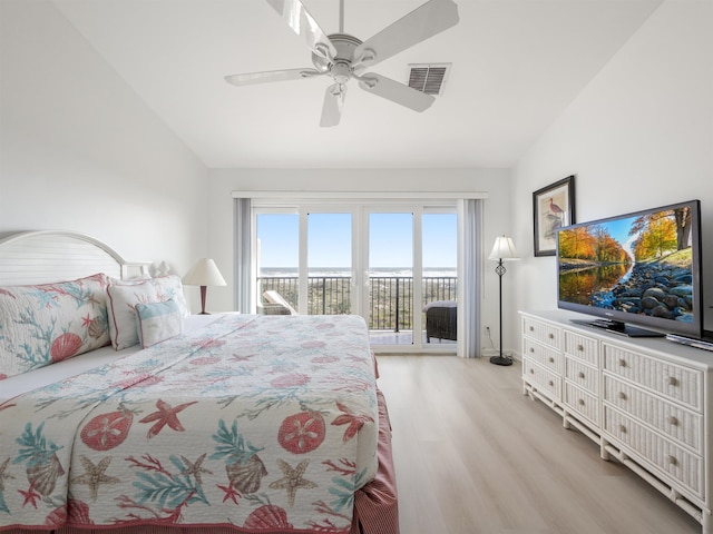 bedroom with access to exterior, ceiling fan, light hardwood / wood-style floors, and vaulted ceiling