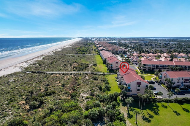 birds eye view of property featuring a water view and a beach view