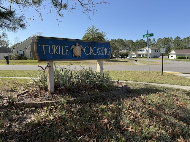 community / neighborhood sign featuring a yard