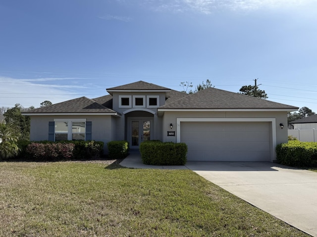 view of front facade featuring a front lawn, french doors, concrete driveway, and stucco siding