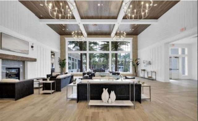 46 Curved Bay Trl, Ponte Vedra, FL 32081 - living room featuring coffered ceiling, a notable chandelier, wooden ceiling, a high ceiling, and wood finished floors
