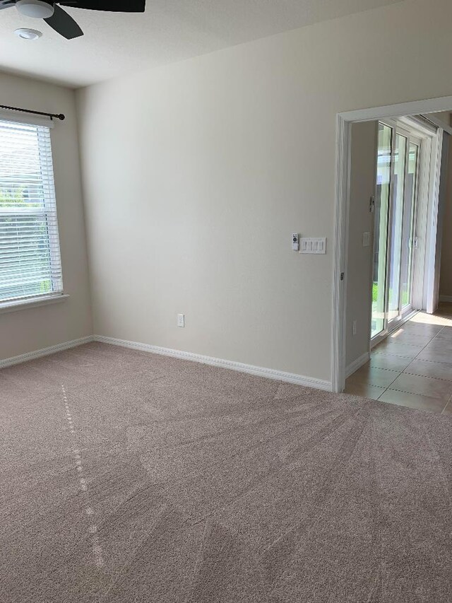 46 Curved Bay Trl, Ponte Vedra, FL 32081 - tiled spare room with carpet floors, baseboards, and ceiling fan