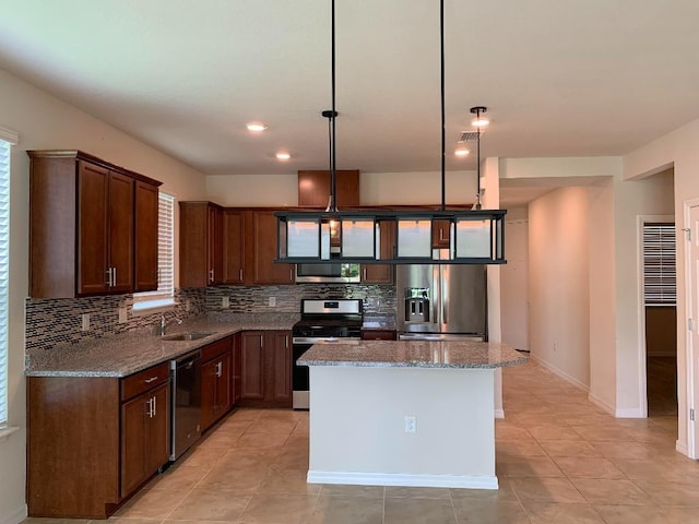 46 Curved Bay Trl, Ponte Vedra, FL 32081 - kitchen featuring stainless steel appliances, a center island, backsplash, a sink, and light stone countertops