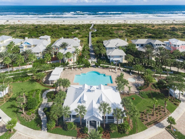 drone / aerial view with a water view and a beach view