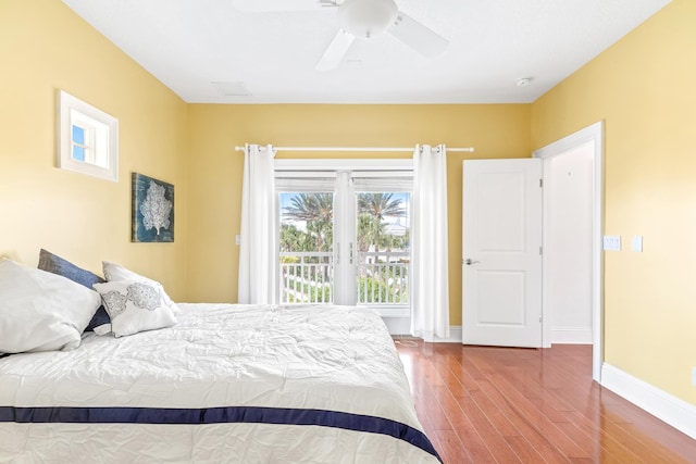 bedroom with access to exterior, ceiling fan, and wood-type flooring