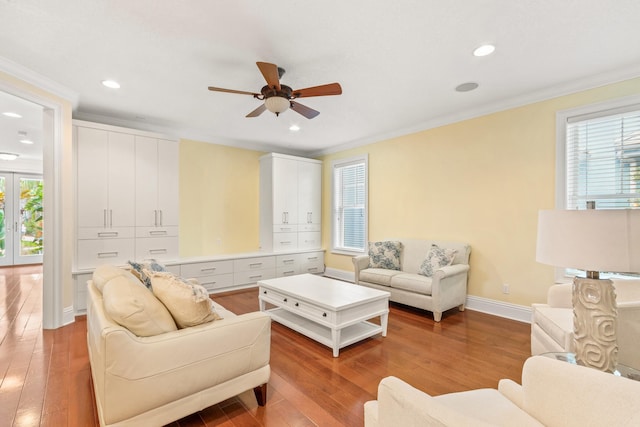 living room featuring hardwood / wood-style floors, french doors, ceiling fan, and crown molding