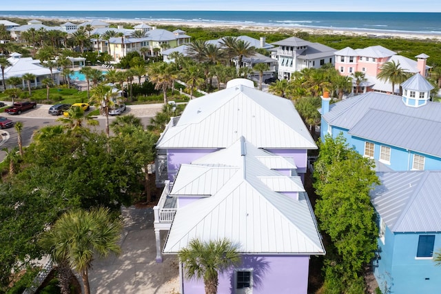 birds eye view of property featuring a beach view and a water view