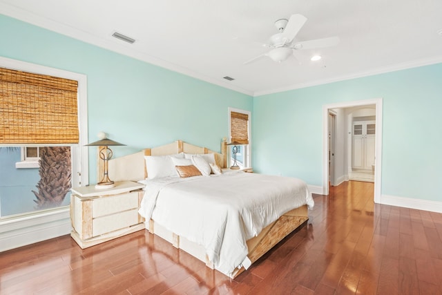 bedroom with ceiling fan, hardwood / wood-style floors, and crown molding