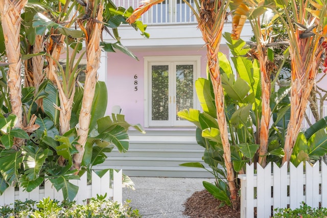 property entrance featuring a balcony and french doors